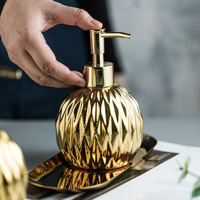 Rund design sæbedispenser i guld